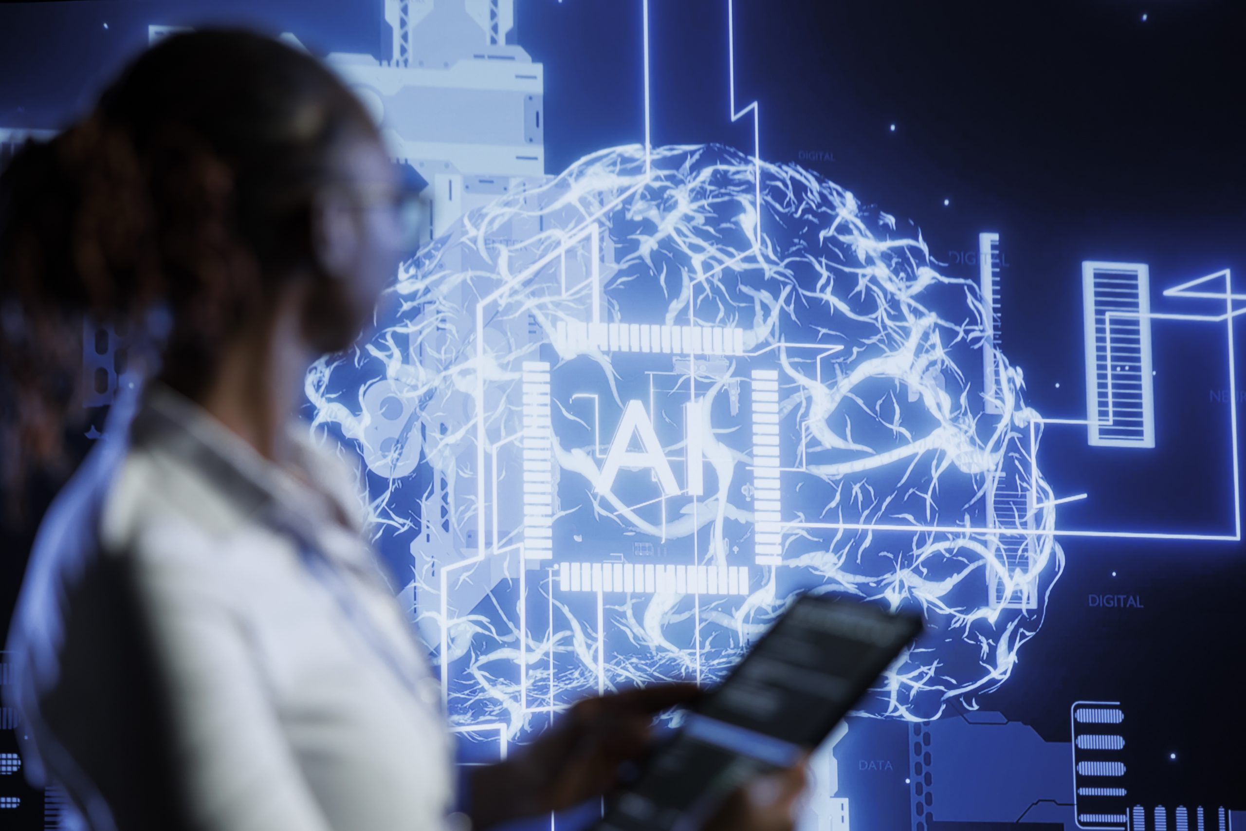 Students using laptops to learn AI without coding in classroom